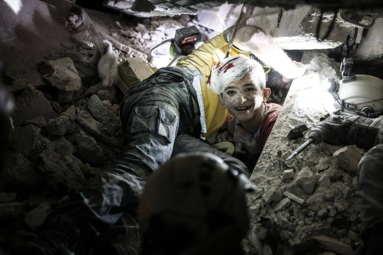 White Helmets save Syrian child from rubble after Russian airstrike on a civilians in Idlib.